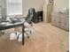 Home office features a large desk with comfortable chair and storage cabinet at 32699 Dashel Palm Ln, Wesley Chapel, FL 33543