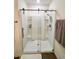 Modern tiled shower featuring updated fixtures and built-in shelves at 32699 Dashel Palm Ln, Wesley Chapel, FL 33543