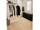 Walk-in closet with shelving, rod hangers and modern dresser at 32699 Dashel Palm Ln, Wesley Chapel, FL 33543