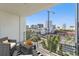 Balcony with city views and seating area features a geometric rug and modern railing at 332 Cocoanut Ave # 505, Sarasota, FL 34236
