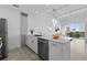 Modern kitchen with quartz countertops and stainless steel appliances flowing into the living space and balcony at 332 Cocoanut Ave # 505, Sarasota, FL 34236