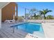 Community pool with lounge chairs, tables and umbrellas in a modern outdoor space at 332 Cocoanut Ave # 505, Sarasota, FL 34236