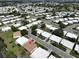 Aerial view of a residential area, highlighting a property with a reddish-brown roof at 3928 90Th N Ter, Pinellas Park, FL 33782