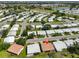 Aerial view displaying a community with beautiful scenery including a golf course and lake at 3928 90Th N Ter, Pinellas Park, FL 33782