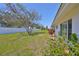 Landscaped backyard featuring a spacious lawn and healthy shrubs along the home's exterior at 3928 90Th N Ter, Pinellas Park, FL 33782
