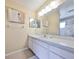 Bathroom with white vanity and large mirror at 3928 90Th N Ter, Pinellas Park, FL 33782
