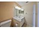 Bathroom showing vanity, toilet and textured wallpaper at 3928 90Th N Ter, Pinellas Park, FL 33782