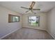 Cozy bedroom featuring neutral carpeting, a ceiling fan, and bright window at 3928 90Th N Ter, Pinellas Park, FL 33782