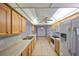 Well-lit kitchen with tile flooring, wooden cabinets, and a ceiling fan at 3928 90Th N Ter, Pinellas Park, FL 33782
