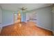 Open living room with hardwood floors connecting the kitchen and other living spaces at 3928 90Th N Ter, Pinellas Park, FL 33782