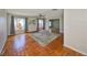 Cozy living room with hardwood floors, large rug, ceiling fan, and an abundance of natural light at 3928 90Th N Ter, Pinellas Park, FL 33782