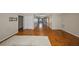 Open-concept living room featuring hardwood floors, neutral walls, and views to the kitchen at 3928 90Th N Ter, Pinellas Park, FL 33782