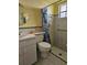 A functional bathroom with a sink, toilet, shower with curtain, and handicap bar at 4206 Tamargo Dr # 4206, New Port Richey, FL 34652