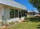 Backyard view of several homes with white exteriors, surrounded by green lawns at 4206 Tamargo Dr # 4206, New Port Richey, FL 34652