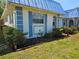 Side view of a well-maintained home with blue accents and tidy landscaping at 4206 Tamargo Dr # 4206, New Port Richey, FL 34652