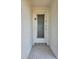 Close-up of the front door featuring a decorative security screen and brick surround at 4206 Tamargo Dr # 4206, New Port Richey, FL 34652