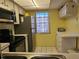 Bright kitchen featuring stainless steel refrigerator, oven, and window view at 4206 Tamargo Dr # 4206, New Port Richey, FL 34652