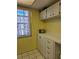 Kitchen with window, yellow walls and cabinets at 4206 Tamargo Dr # 4206, New Port Richey, FL 34652