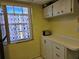 Kitchen with window, light yellow walls and cabinets at 4206 Tamargo Dr # 4206, New Port Richey, FL 34652