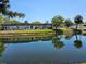 Scenic view of a community reflected in a tranquil pond under a clear blue sky at 4206 Tamargo Dr # 4206, New Port Richey, FL 34652