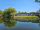 Picturesque view of community homes reflected on a peaceful pond at 4206 Tamargo Dr # 4206, New Port Richey, FL 34652