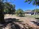 Wide open backyard with a few trees providing shade, and the house on the right side at 4363 Elwood Rd, Spring Hill, FL 34609