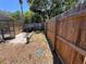 Fenced backyard with a screened-in porch and partial view of the pool at 4363 Elwood Rd, Spring Hill, FL 34609
