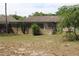 View of the backyard with a screened in porch with decorative lattice at 4363 Elwood Rd, Spring Hill, FL 34609