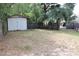 Fenced backyard with a shed and a few palm trees, with plenty of space at 4363 Elwood Rd, Spring Hill, FL 34609