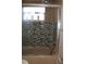 Bathroom with glass-enclosed shower, brown tile, and toiletries on the side at 4363 Elwood Rd, Spring Hill, FL 34609