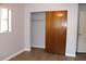 Bedroom with hardwood flooring, one window, light gray painted walls, and closet with sliding wood doors at 4363 Elwood Rd, Spring Hill, FL 34609