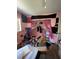 Cluttered pink bedroom with pink sequin curtains and a ceiling fan at 4363 Elwood Rd, Spring Hill, FL 34609
