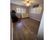 Bedroom with hardwood flooring, two windows, ceiling fan, and gray painted walls at 4363 Elwood Rd, Spring Hill, FL 34609