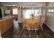 Cozy dining area with wood floors, table with seating, and sliding glass doors to the outdoors at 4363 Elwood Rd, Spring Hill, FL 34609
