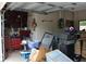 View of a cluttered garage with a red toolbox, boxes and roller blades at 4363 Elwood Rd, Spring Hill, FL 34609