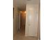 Hallway with neutral paint and tile floors, provides access to different areas of the house at 4363 Elwood Rd, Spring Hill, FL 34609