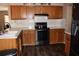 Bright kitchen showcasing wood cabinets, black appliances, and ample countertop space at 4363 Elwood Rd, Spring Hill, FL 34609