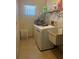 Functional laundry room equipped with a washer, dryer, and utility sink for added convenience at 4363 Elwood Rd, Spring Hill, FL 34609