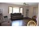 Cozy living room with ample natural light, plush sofas, and hardwood flooring at 4363 Elwood Rd, Spring Hill, FL 34609