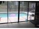 View of the pool area from the enclosed tiled room at 4363 Elwood Rd, Spring Hill, FL 34609
