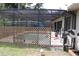 Backyard swimming pool that is screened in with a wooden fence surrounding the pool area at 4363 Elwood Rd, Spring Hill, FL 34609