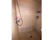 Shower stall features beige tiling, handheld shower head and mounted shelves with toiletries at 4363 Elwood Rd, Spring Hill, FL 34609