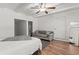 Open bedroom with sitting area featuring hardwood floors, ceiling beams, and ensuite bathroom at 4400 2Nd S Ave, St Petersburg, FL 33711