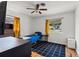Cozy bedroom featuring hardwood floors, a ceiling fan, natural light, and a black and white rug at 4400 2Nd S Ave, St Petersburg, FL 33711