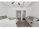 Bedroom with bed and couch featuring hardwood floors, ceiling beams, and ensuite bathroom at 4400 2Nd S Ave, St Petersburg, FL 33711
