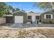 Curb appeal of the home highlighting the front door, garage, windows, and lovely front yard at 4400 2Nd S Ave, St Petersburg, FL 33711