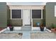 Charming front porch with a white door and fresh landscaping, creating a welcoming entrance to the home at 4400 2Nd S Ave, St Petersburg, FL 33711