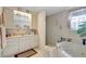 Bright bathroom featuring a vanity, soaking tub, and a separate standing shower at 4610 47Th N Way, St Petersburg, FL 33702
