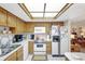 Clean kitchen featuring white appliances, bright overhead lighting, and tile flooring at 4610 47Th N Way, St Petersburg, FL 33702