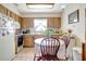 Cozy kitchen features wooden cabinetry, tiled flooring, and a quaint breakfast nook with a round table at 4610 47Th N Way, St Petersburg, FL 33702